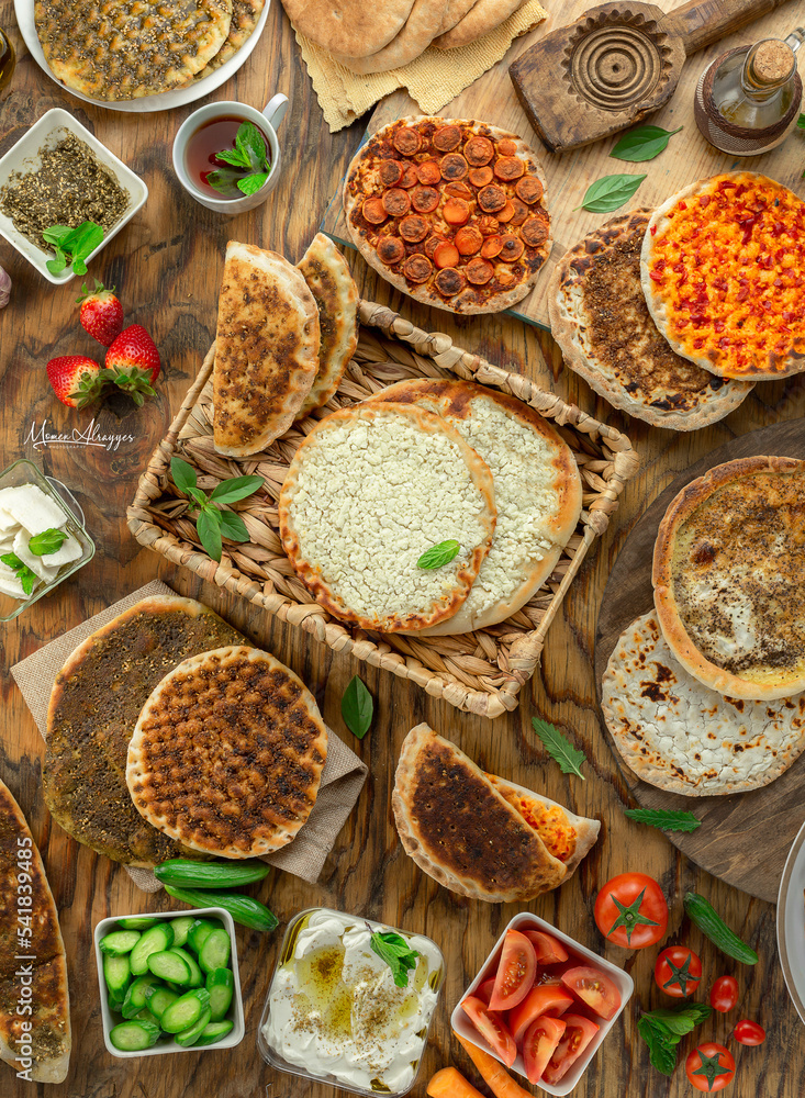 Cheese and Zaatar Manakeesh with Cucumber and tomato Photos Adobe Stock