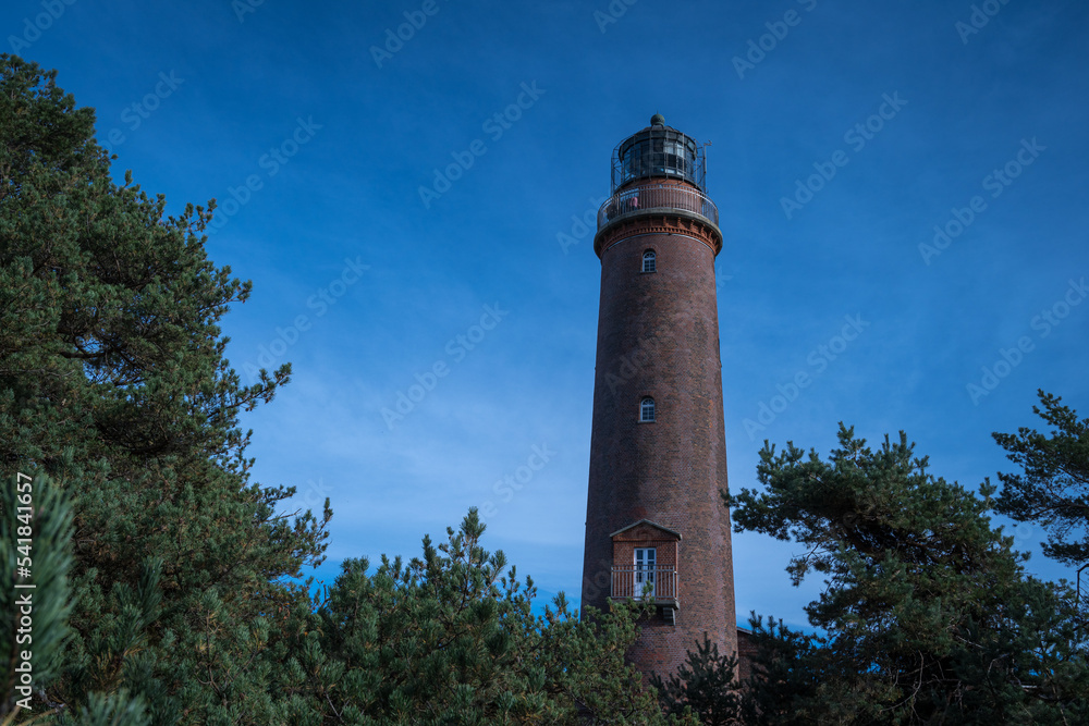 Leuchtturm Darßer Ort mit Kiefernwald und blauen Himmel