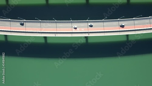 Bird's eye view of cars driving on the Iron Cove Bridge in Sydeny, Australia with a calm green sea photo