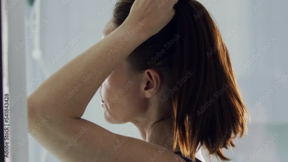 close up shot of a lady loosening her hair after her make up close up shot of a lady loosening her hair after her make up