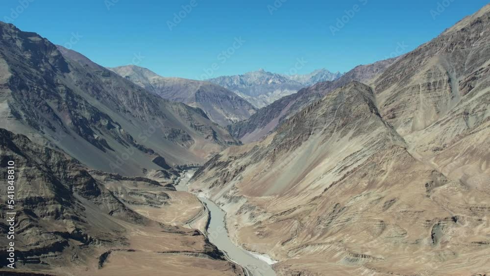 Aerial view of Sangam – the confluence of the Indus river (green colour) and the Zanskar river (blue or brown colour depending on the season) in Ladakh, India. Aerial view of Sangam – the confluence of the Indus river (green colour) and the Zanskar river (blue or brown colour depending on the season) in Ladakh, India.
