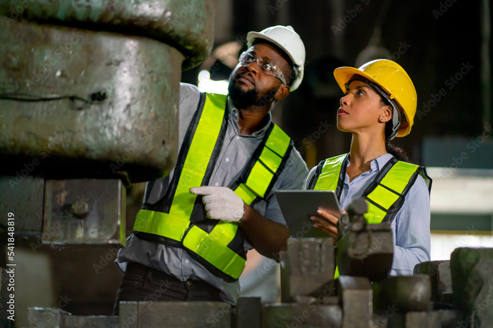 African American factory woman hold tablet and discuss about machine ...