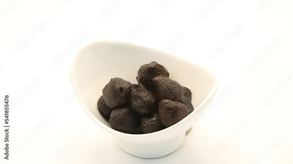 black garlic in a white cup black garlic in a white cup