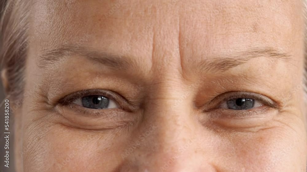 Close up cheerful smiling eyes of a mature woman Close up cheerful smiling eyes of a mature woman