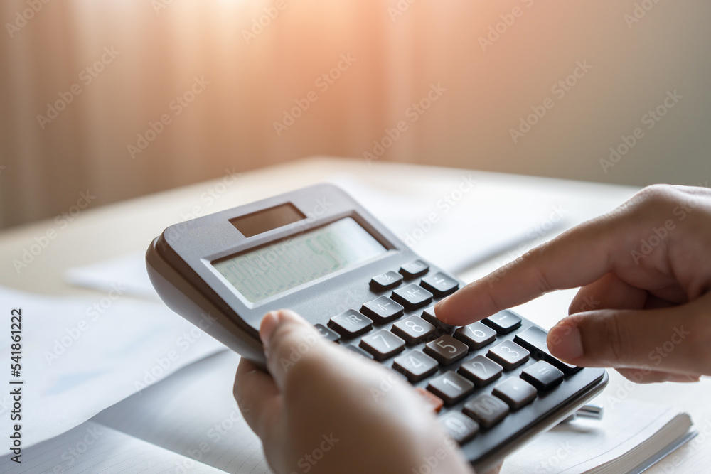 Woman calculate bill budget payment, home accounting concept with calculator. Woman calculate bill budget payment, home accounting concept with calculator.