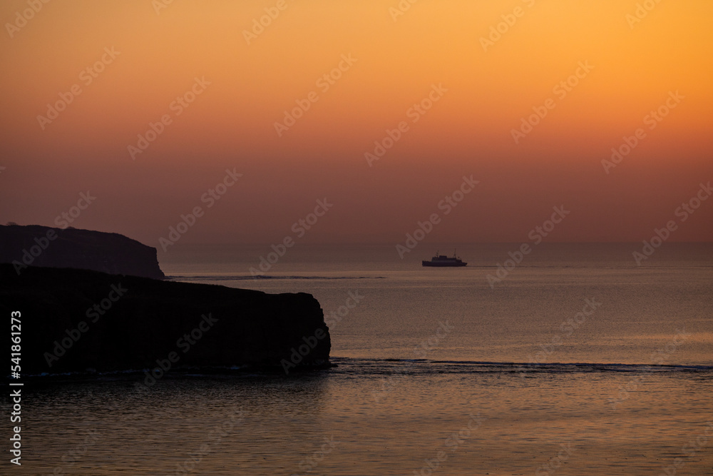 Passenger ferry goes by sea at sunset. Sea sunset in Vladivostok.