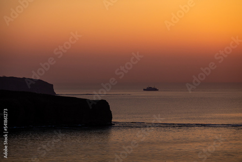 Passenger ferry goes by sea at sunset. Sea sunset in Vladivostok.