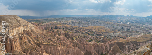 Panoramic aerial view of the rocky mountains in Cappadocia against a stormy sky, Turkey photo