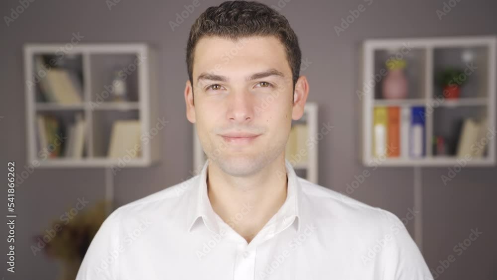 The man glances up and approves.
Man looking at camera nods affirmatively.
The man glances up and approves.
Man looking at camera nods affirmatively.