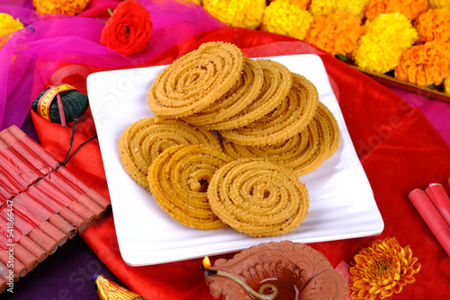 Indian Traditional Snack Chakli, a spiral shaped, Chakali or murukku Indian Traditional Tea Time Snack, Traditional Diwali festival snacks in India. photo