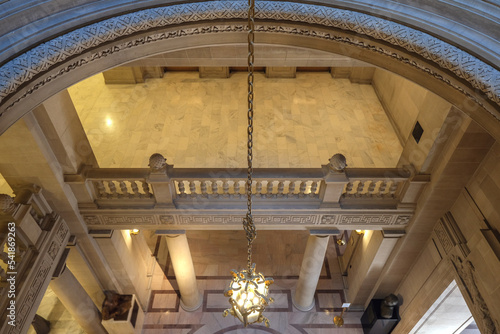 Breathtaking architecture details of panoramic dome columns scenic building interior view with historic walls, chandeliers, brass railings, marble statues in public city hall landmark