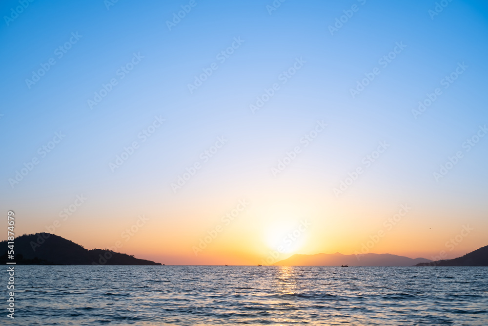 Sunset over the bay, warm evening, idea for background or advertising Sunset over the bay, warm evening, idea for background or advertising