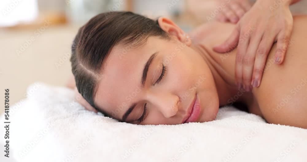 Health, relax and woman getting back massage at luxury spa lying on table with smile and massage therapist hands on back. Wellness, body care and physiotherapy service at beauty salon for happy women Health, relax and woman getting back massage at luxury spa lying on table with smile and massage therapist hands on back. Wellness, body care and physiotherapy service at beauty salon for happy women