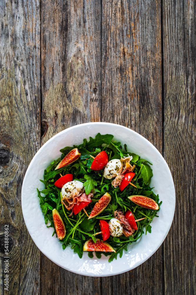 Fresh salad mozzarella, crudo ham, fig, cherry tomatoes and leafy