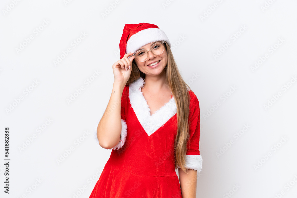 Young caucasian woman dressed as mama noel isolated on white background with glasses and happy Young caucasian woman dressed as mama noel isolated on white background with glasses and happy