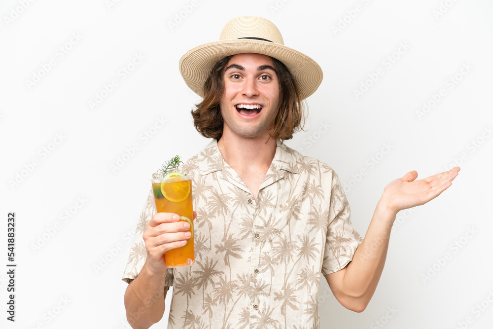 Young handsome man holding a cocktail isolated on white background with shocked facial expression Young handsome man holding a cocktail isolated on white background with shocked facial expression