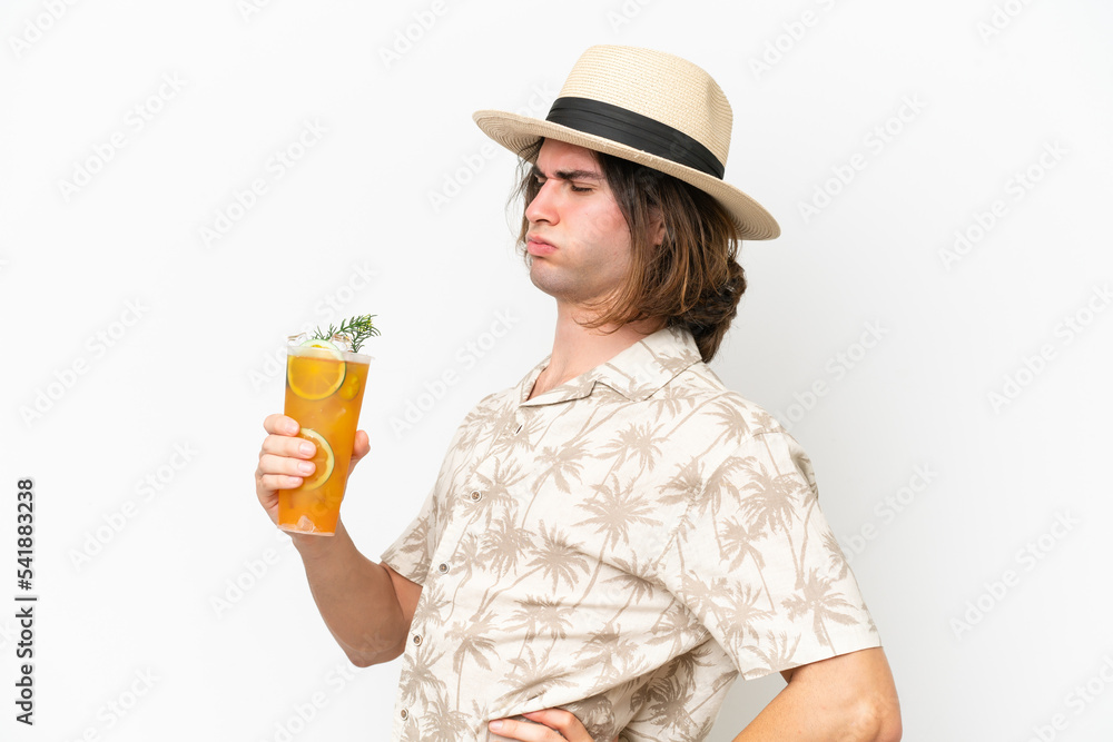 Young handsome man holding a cocktail isolated on white background suffering from backache for having made an effort Young handsome man holding a cocktail isolated on white background suffering from backache for having made an effort