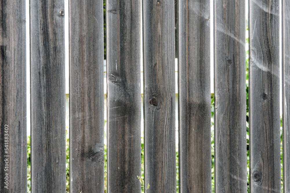 An old wooden fence made of planks An old wooden fence made of planks