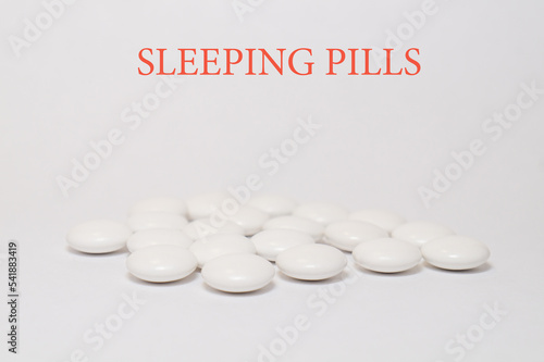 White medical sleeping pills a white background