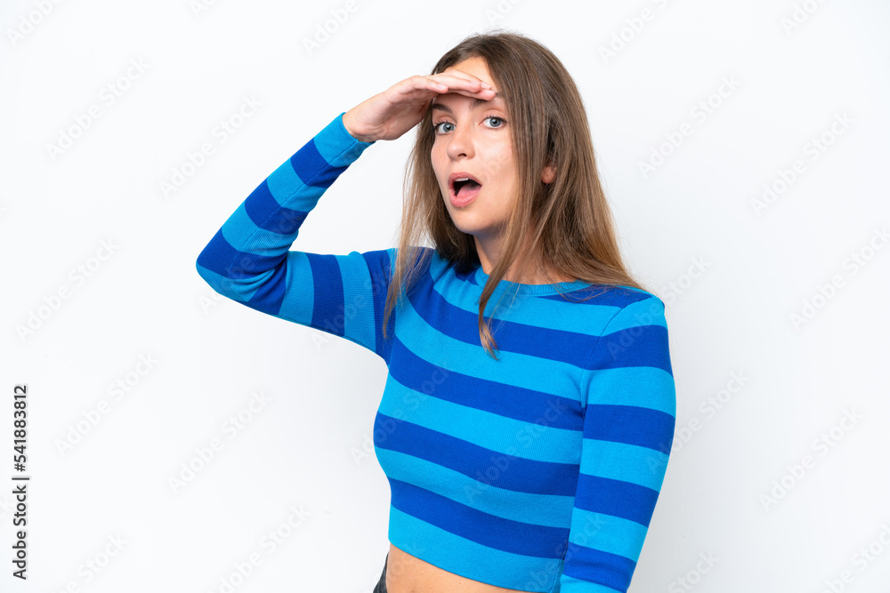 Young caucasian woman isolated on white background doing surprise gesture while looking to the side Young caucasian woman isolated on white background doing surprise gesture while looking to the side