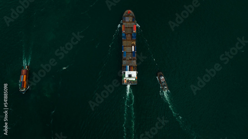 Container ship carrying container for import and export international in sea aerial top view photograph from drone