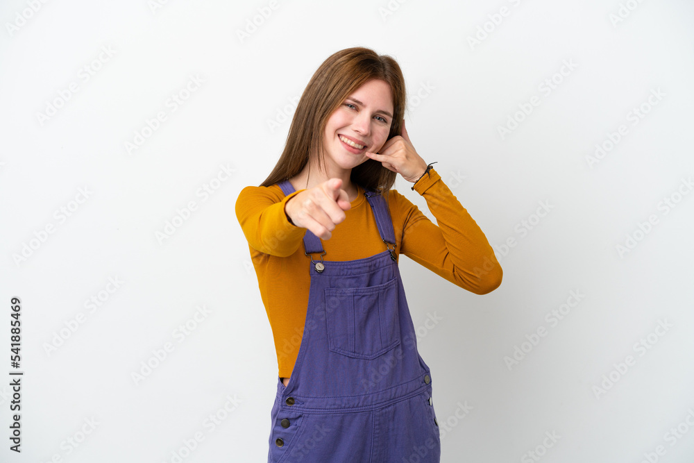 Young English woman isolated on white background making phone gesture and pointing front Young English woman isolated on white background making phone gesture and pointing front