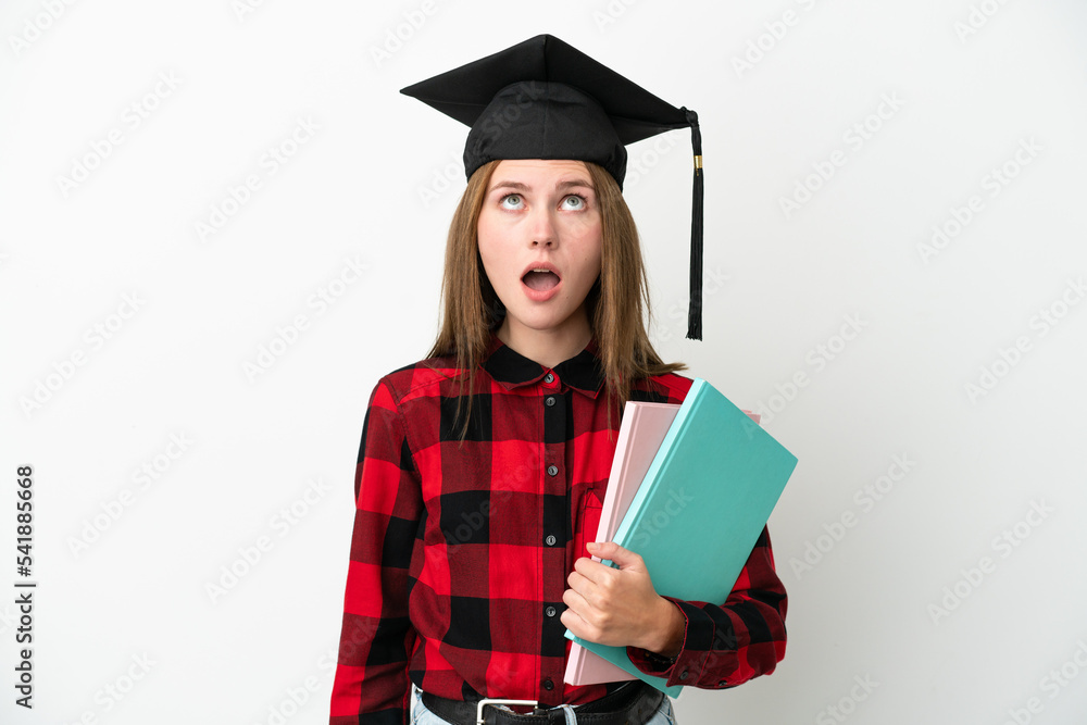Young English student woman isolated on white background looking up and with surprised expression Young English student woman isolated on white background looking up and with surprised expression