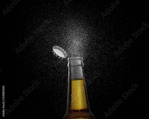 Closeup photo of an Brown beer bottle splashing beer drops on a black background. Beer cap flying on top of the bottle. 3d render