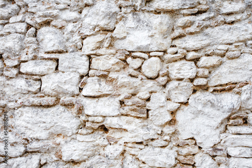Wall old made of big crooked broken stones, rough blocks  background. © elenvd
