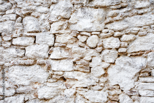 Wall old made of big crooked broken stones, rough blocks background.