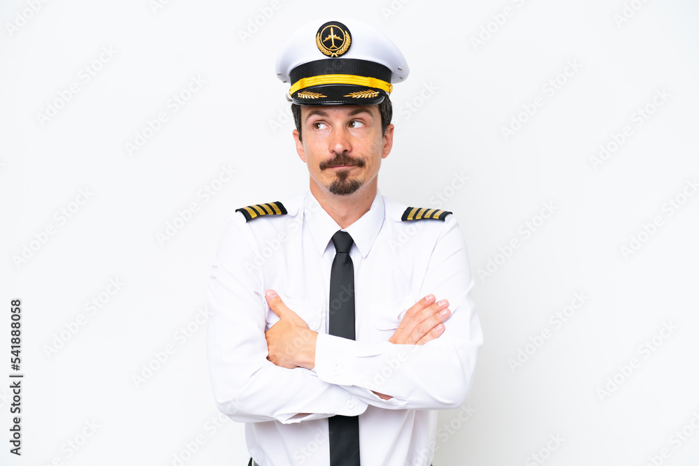 Airplane caucasian pilot isolated on white background making doubts gesture while lifting the shoulders