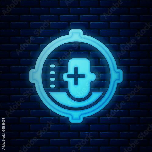 Glowing neon Headshot icon isolated on brick wall background. Sniper and marksman is shooting on the head of man, lethal attack, assault and assassination. Vector