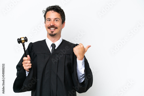 Young judge caucasian man isolated on white background pointing to the side to present a product