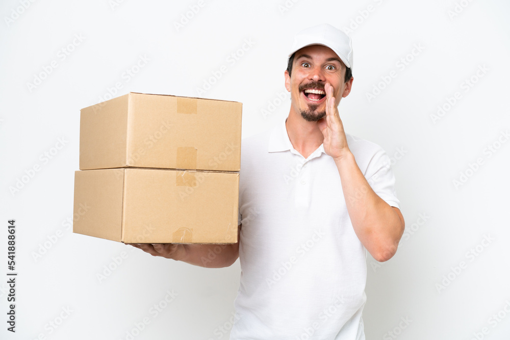 Delivery caucasian man isolated on white background shouting with mouth wide open Delivery caucasian man isolated on white background shouting with mouth wide open