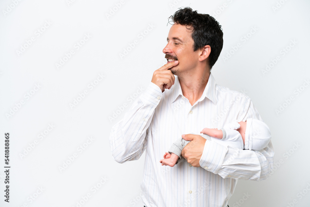 Young man with his newborn baby thinking an idea and looking side Young man with his newborn baby thinking an idea and looking side