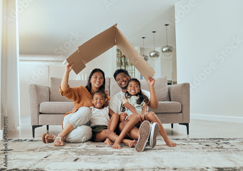 Family, care and home insurance roof portrait with parents protecting house and children. Cardboard, covering and safety with parents keeping with kids safe. Love, mortgage and family house cover photo