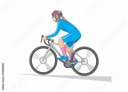 Woman in blue cycling clothes riding from side view