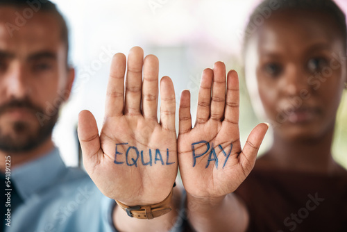 Fotografía Hands, equality and empowerment with a business man and woman showing an equal pay notice in their palms