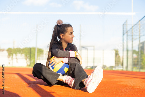 Free Download Cute girl playing ball. Girl with a blue-yellow volleyball - GFXLoad