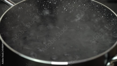 Throwing vermicelli in boiling water. Cooking pasta Vermicelli in a pot boiling