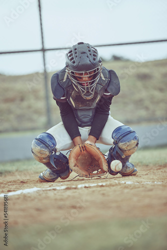 Baseball, sports and ball with a catcher on a grass pitch or field during a game or match outdoor. Fitness, exercise and catch with a male baseball player playing a competitive sport outside