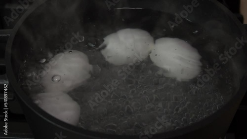 Boiling eggs on a gas stove. Top view close-up. Slow motion