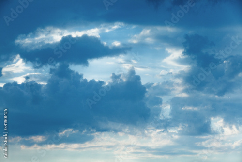 Clouds in the blue sky in different shapes.