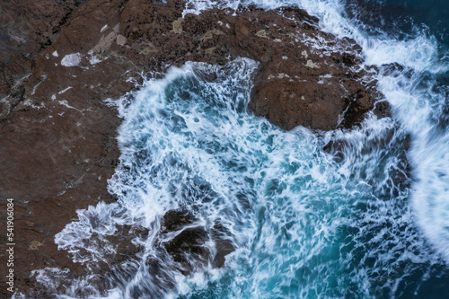 Beautiful aerial drone landscape image of Prussia Cove at sunrise in Cornwall England with atmospheric daramatic sky and clouds