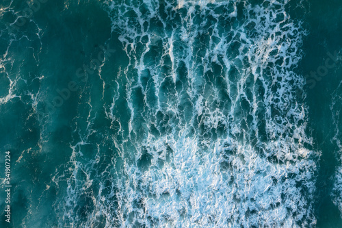 Beautiful aerial drone landscape top down view of wave detail in turquoise colored receding waves