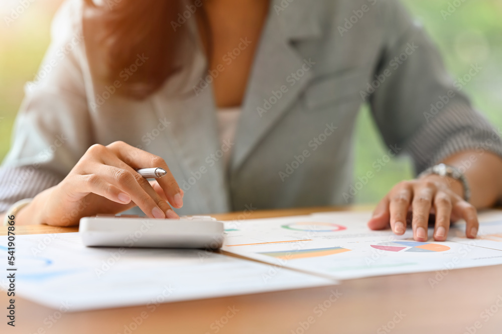 Close up with Businesswoman's hands using calculate expenses expenditures, manage budget, analysis data charts and graphs, Business finances and and accounting concept. Close up with Businesswoman's hands using calculate expenses expenditures, manage budget, analysis data charts and graphs, Business finances and and accounting concept.