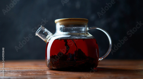 Teapot of tea standing on wooden table