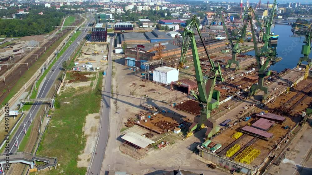 Drone shot of harbor cranes on the wharf of the dry docks of the Gdansk shipyard Drone shot of harbor cranes on the wharf of the dry docks of the Gdansk shipyard