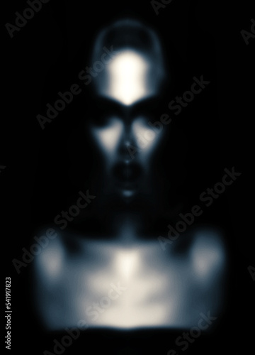 Fine art, sci-fi concept. Abstract and futuristic looking alien or extraterrestrial portrait. Defocused, out of focus and blurred image. Image contain noise and grain. Toned image with blue color