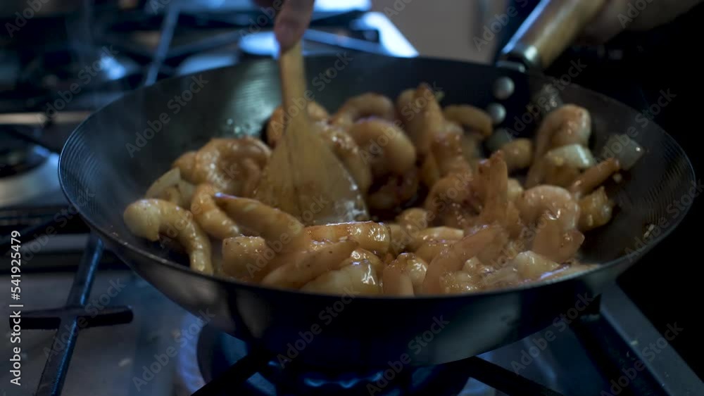 Frozen Spicy Prawns Being Cooked, Heated And Stirred And Wok In Kitchen. Locked Off Frozen Spicy Prawns Being Cooked, Heated And Stirred And Wok In Kitchen. Locked Off